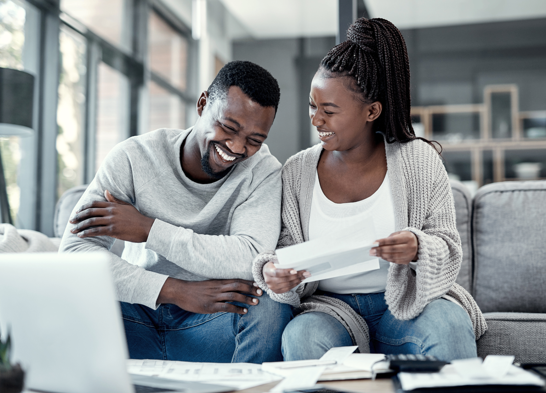 Happy couple reviewing property documents together